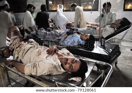 PESHAWAR, PAKISTAN - JUN 12: Paramedic staff gives treatment to injured men who were injured in explosions at Khyber Supermarket, on June 12, 2011 in Peshawar.