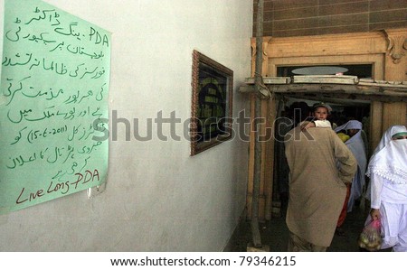 PESHAWAR, PAKISTAN - JUN 15: A protest poster is seen pasted on a wall of Khyber Teaching hospital during strike of doctors to condemn the police torture on doctors on June 15, 2011 in Peshawar.