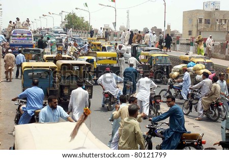 HYDERABAD, PAKISTAN - JUN 28: A view of traffic jam as angry protesters block road against firing incident at Khawaja Ghareeb Nawaz Bridge on June 28, 2011in Hyderabad, Pakistan.
