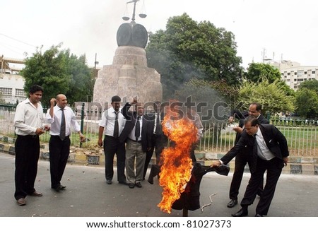 KARACHI, PAKISTAN - JUL 14: Lawyers burn effigy as they are protesting against Peoples Party (PPP) Senior Leader, Dr.Zulfiqar Mirza\'s statements against (MQM) on July 14, 2011 in Karachi, Pakistan.