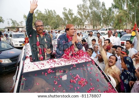 LARKANA, PAKISTAN - JUL 17: Sindh Law Minister, Ayaz Soomro being welcomed by supporters of Peoples Party (PPP) during his visits on July 17, 2011in Larkana, Pakistan.