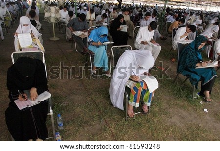PESHAWAR, PAKISTAN - JUL 24: Students solve papers during entry test for Khyber Medical College (KMC) held at Karnal Sher Khan Shaheed Stadium on July 24, 2011in Peshawar, Pakistan.