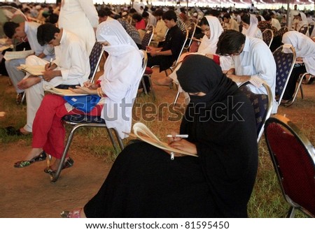 PESHAWAR, PAKISTAN - JUL 24: Students solve papers during entry test for Khyber Medical College (KMC) held at Karnal Sher Khan Shaheed Stadium on July 24, 2011in Peshawar, Pakistan.