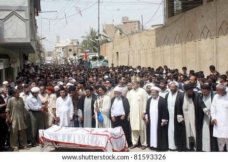 KARACHI, PAKISTAN - JUL 24: People offer funeral prayer of Mukhtar Bukhari advocate who was gunned down by unidentified gunmen yesterday, at Abbas Town on July 24, 2011in Karachi, Pakistan.