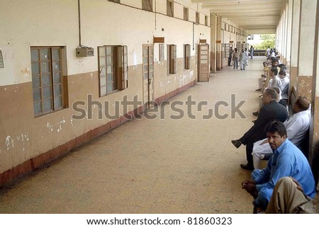 KARACHI, PAKISTAN - JUL 28: People who came for their case-hearing are seen worried at city court premises due to strike of lawyers against target killings on  July 28, 2011in Karachi, Pakistan.