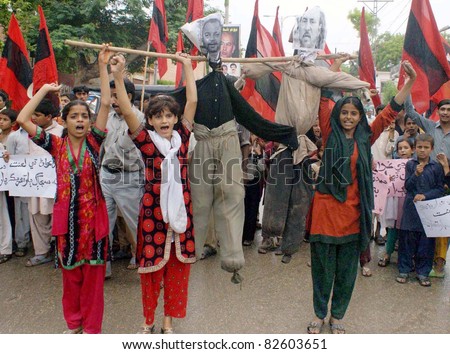 HYDERABAD, PAKISTAN - AUG 10: unidentified supporters of Sujag Bar Tehreek hold effigies as they are protesting against restoration of Local Bodies Ordinance 2001 in Sindh  on August 10, 2011in Hyderabad.