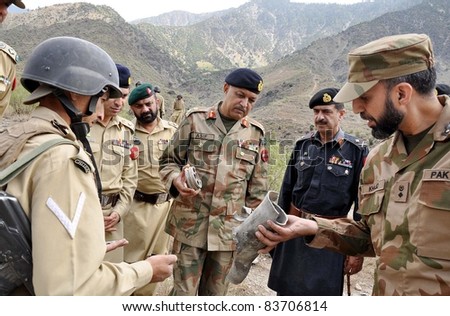 PESHAWAR, PAKISTAN - AUG 29: Corps Commander Lt.Gen.Asif Yasin Malik inspects the heavy weapon rounds fired by miscreants at Langurbut post on August 29, 2011in Chitral, Peshawar, Pakistan.