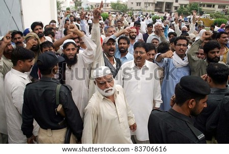 KARACHI, PAKISTAN - AUG 29: Employees of electric supply company shout slogans in favor of their demands during protest demonstration at KESC head office on August 29, 2011 in Karachi, Pakistan.
