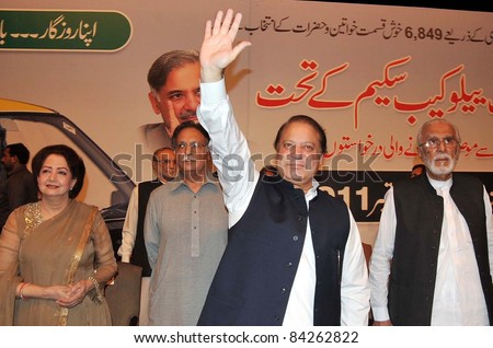 LAHORE, PAKISTAN - SEPT 07: Muslim League-N President, Nawaz Sharif waves hand to public during a public meeting on occasion of the Yellow Cab Scheme Draws held in Lahore on, September 07, 2011.