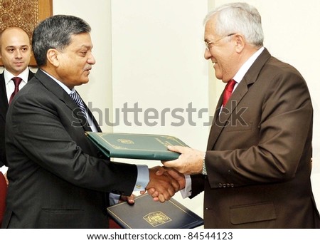 ISLAMABAD - SEPT 12: Economic Affairs Division Sec, Abdul Wajid and Romania Ambassador, Emilian Ion exchanging Agreement on Economic, Scientific and Technical Cooperation between Pakistan September 12, 2011