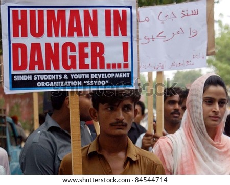 HYDERABAD - SEPT 12: Supporters of Sindh Students and Youth Development Organization (SSYDO) hold posters during rally in favor of rain and flood affected people in Hyderabad on September 12, 2011.