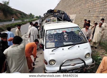 PESHAWAR, PAKISTAN: People gather near a school van after it was attacked by militants at Matni area in Peshawar, Pakistan on September 13, 2011.