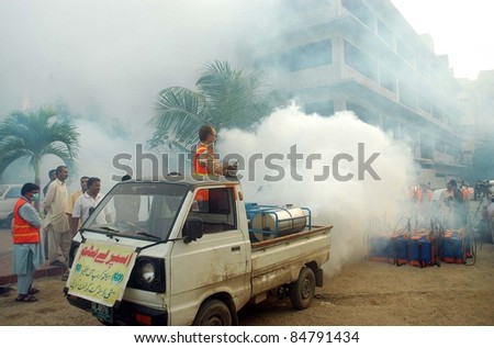 KARACHI, PAKISTAN - SEPT 16: Health workers fumigate against the Dengue mosquitoes during campaign under the supervision of city district government in Karachi September 16, 2011.