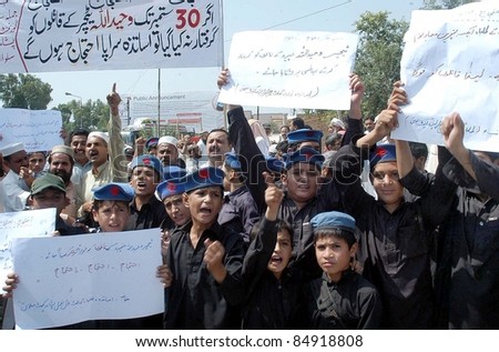 PESHAWAR, PAKISTAN - SEPT 17: Teachers and students of a government school are protesting against killing of the Teacher Waheedullah, during demonstration in Peshawar on September 17, 2011.