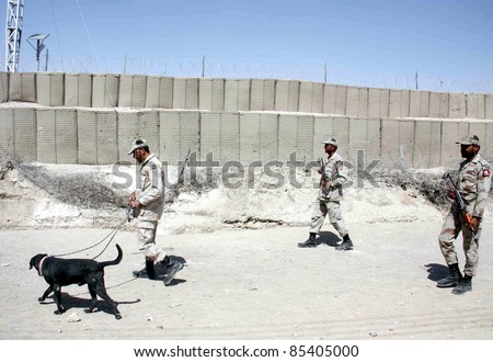 CHAMAN, PAKISTAN - SEPT 26: Security officials with snuffer-dog patrol Pak-Afghan border as security has been beefed up at border due to bad law and order situation on September 26, 2011in Chaman.