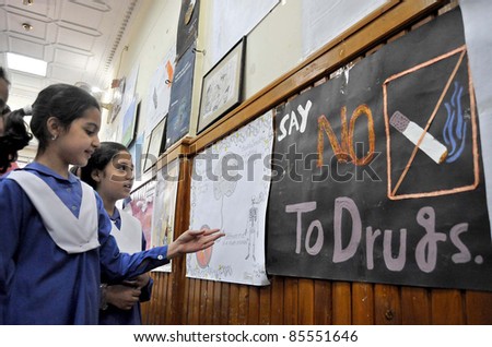 PESHAWAR, PAKISTAN -SEPT 28: Schoolchildren look paintings during an exhibition arranged by Anti-Narcotics Force held on September 28, 2011 in Peshawar.