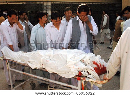 QUETTA, PAKISTAN -OCT 04: People weep over dead body of a firing victim who was gunned down in terrorists attack at Bolan medical complex hospital (BMC) on October 04, 2011in Quetta, Pakistan