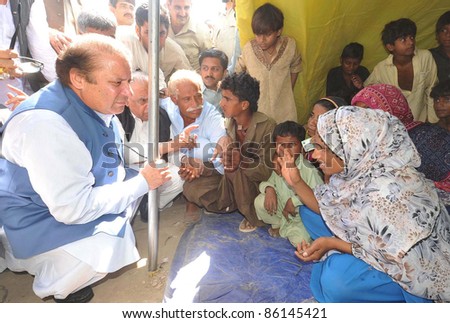TANDO ADAM, PAKISTAN - OCT 07: Muslim League-N President, Nawaz Sharif talks with flood affectees in a relief camp during his visits on October 07, 2011in Tando Adam.