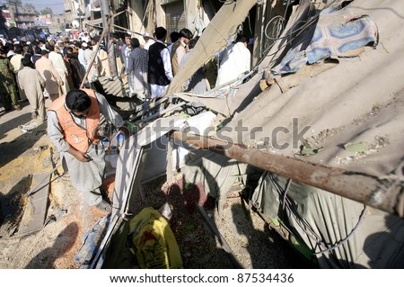 PESHAWAR, PAKISTAN - OCT 27: People look damaged shops which were destroyed in explosion after explosion at Rampura Bazaar on October 27, 2011 in Peshawar.