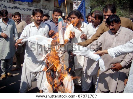 HYDERABAD, PAKISTAN - NOV 01: Activists of Sindh Peoples Students Federation (SPSF) burn effigy as they are protesting against Muslim League-N  Nawaz Sharif on November 01, 2011 in Hyderabad, Pakistan.
