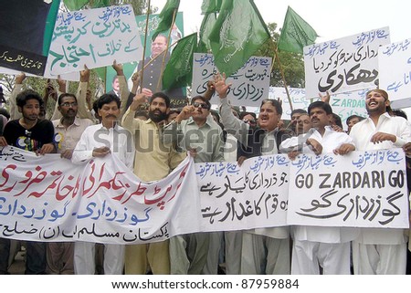 HYDERABAD, PAKISTAN - NOV 02: Supporters of Muslim League-N chant slogans in favor of their demands during protest rally in Hyderabad on November 02, 2011in Hyderabad.