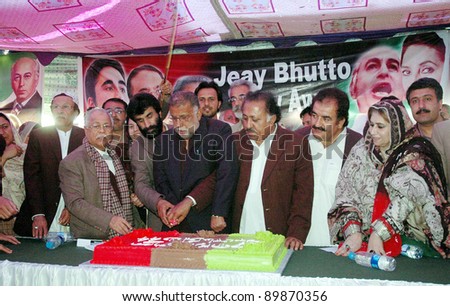 QUETTA, PAKISTAN - NOV 30: Peoples Party leader, Mir Sadiq Umrani along with other cuts cake on occasion of the PPP Forty-fifth Foundation Day ceremony held on November 30, 2011in Quetta.