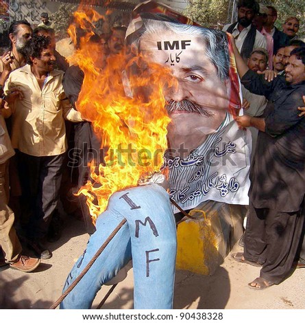 HYDERABAD, PAKISTAN - DEC 08: WAPDA Hydro Electric Central Labor Union burn an effigy as they are protesting against IMF and privatization of power companies, on December 08, 2011in Hyderabad.