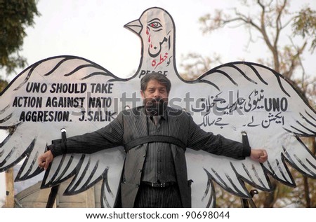 ISLAMABAD, PAKISTAN - DEC 09: Human rights activist J.Salik is protesting against NATO attack in the Country during demonstration on December 09, 2011 in Islamabad.