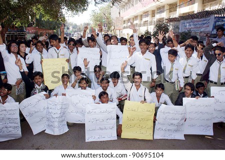 HYDERABAD, PAKISTAN - DEC 12: Govt.Degree College Qasimabad students chant slogans against education board during a protest demonstration at Hyderabad press club on December 12, 2011.