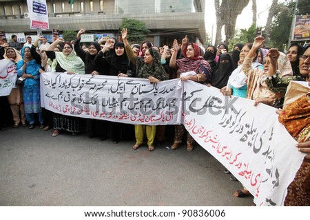 KARACHI, PAKISTAN - DEC 14: Lady Health workers chant slogans in favor of their demands during a protest demonstration arranged by Lady Health Workers Association at Karachi press club on Dec. 14, 2011 in Karachi, Pakistan.