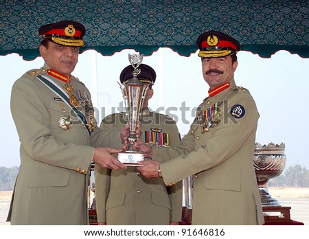 GUJRANWALA, PAKISTAN, DEC 29: Chief of the Army Staff, Gen.Ashfaq Pervez Kayani gives away trophy during graduation ceremony of Army Aviation pilots held in Gujranwala on December 29, 2011.