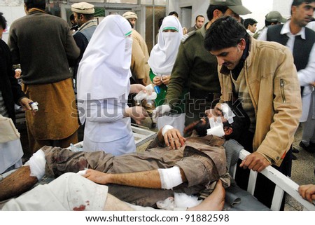 PESHAWAR, PAKISTAN, JAN 03: Paramedic staff gives treatment to an injured man who was injured in explosion, at a hospital in Peshawar on Tuesday, January 03, 2012.