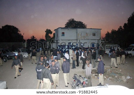 KARACHI, PAKISTAN, JAN 03: Policemen gather after angry mob attack against police operation against encroachments at Dalmia area, at Aziz Bhatti police chowki building in Karachi, January 03, 2012.