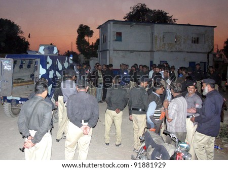 KARACHI, PAKISTAN, JAN 03: Policemen gather after angry mob attack against police operation against encroachments at Dalmia area, at Aziz Bhatti police chowki building in Karachi , January 03, 2012.