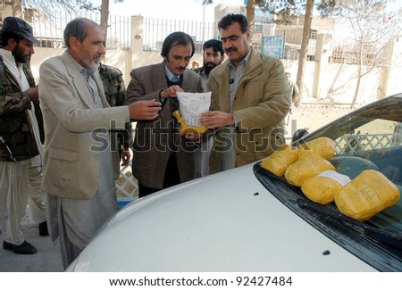 QUETTA, PAKISTAN, JAN 09: Customs officials inspect seized packs of drug (heroine) which were recovered from a vehicle, during press conference in Quetta on Monday, January 09, 2012.