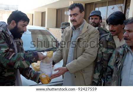 QUETTA, PAKISTAN, JAN 09: Customs officials inspect seized packs of drug (heroine) which were recovered from a vehicle, during press conference in Quetta on Monday, January 09, 2012.