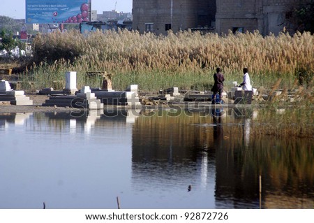 KARACHI, PAKISTAN - JAN 16: A view of stagnant water at Gora Qabristan (graveyard) premises needs the attention of concerned department, on January 16, 2012 in Karachi.