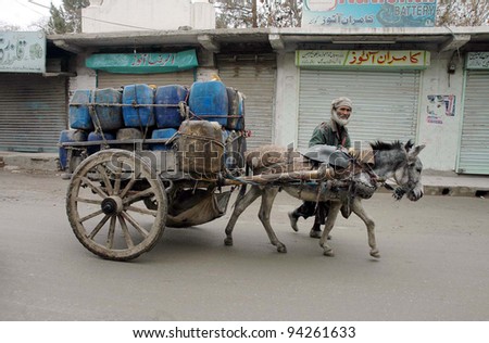 QUETTA, PAKISTAN - FEB 03: A donkey-cart rider passes through closed shops during shutter down strike on the call of Baloch Republican Party in favor of their demands on February 03, 2012 in Quetta, Pakistan.