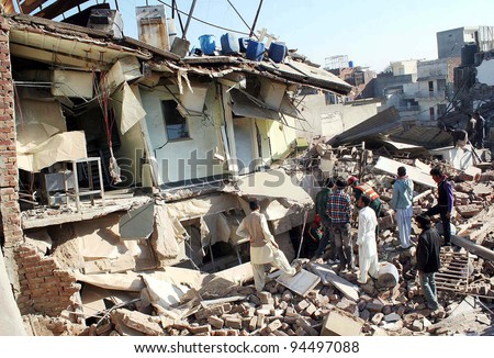 LAHORE, PAKISTAN - FEB 06: Rescue workers busy in rescue operation at the site of building collapse incident on February 06, 2012 in Lahore.