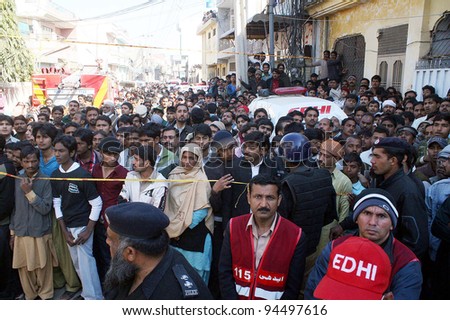 LAHORE, PAKISTAN - FEB 06: A huge number of people gather at the site of building collapse incident on February 06, 2012 in Lahore.