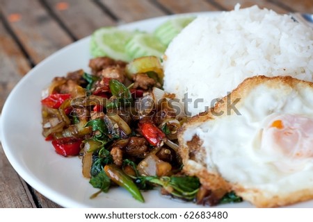 Rice topped with stir-fried pork and basil with fried egg