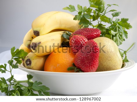 horizontal fresh fruits with bananas, strawberries, oranges and apples from the side