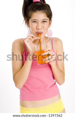 A young happy asian woman drinking an orange soda