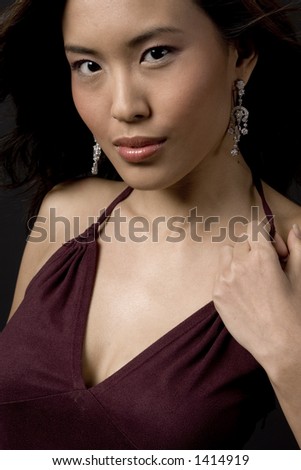 A tightly cropped image of a beautiful asian model in evening dress