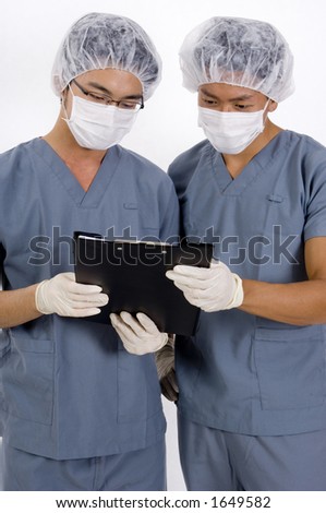 Two medical personnel review some case notes