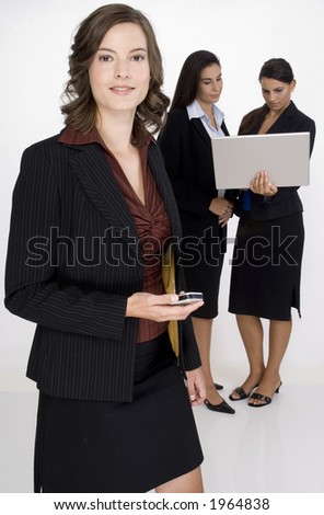 A young woman executive standing in front of her two colleagues