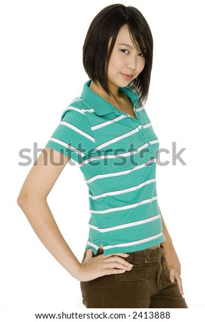 An attractive young asian woman in green polo shirt and brown trousers on white background