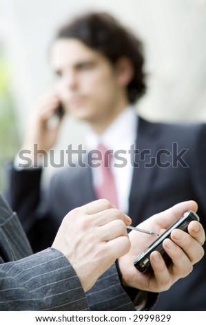 People communicating with different mobile devices (shallow depth of field used)