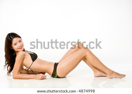 A young beautiful Asian woman in bikini sitting on white background