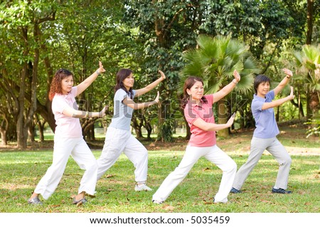 A group of asian ladies exercising in the park